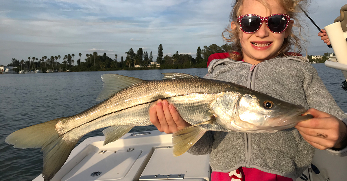 kid catching snook